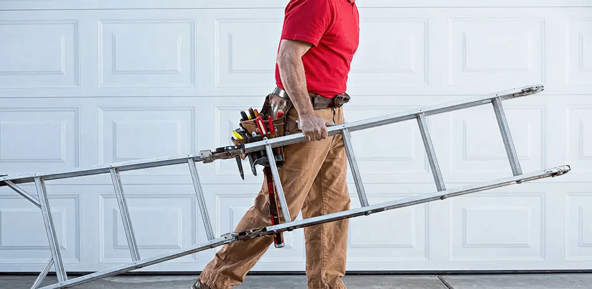 Garage door repair technician arriving with tools and ladder in Overland Park, KS